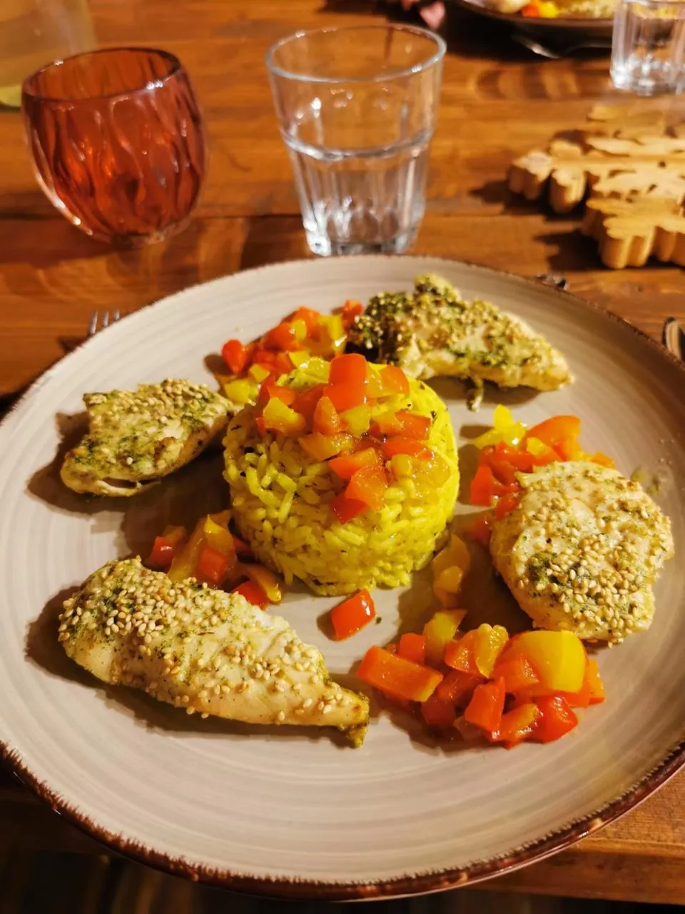 Filets de poulet en croûte d'herbes et de sésame, riz safrané et brunoise de poivrons